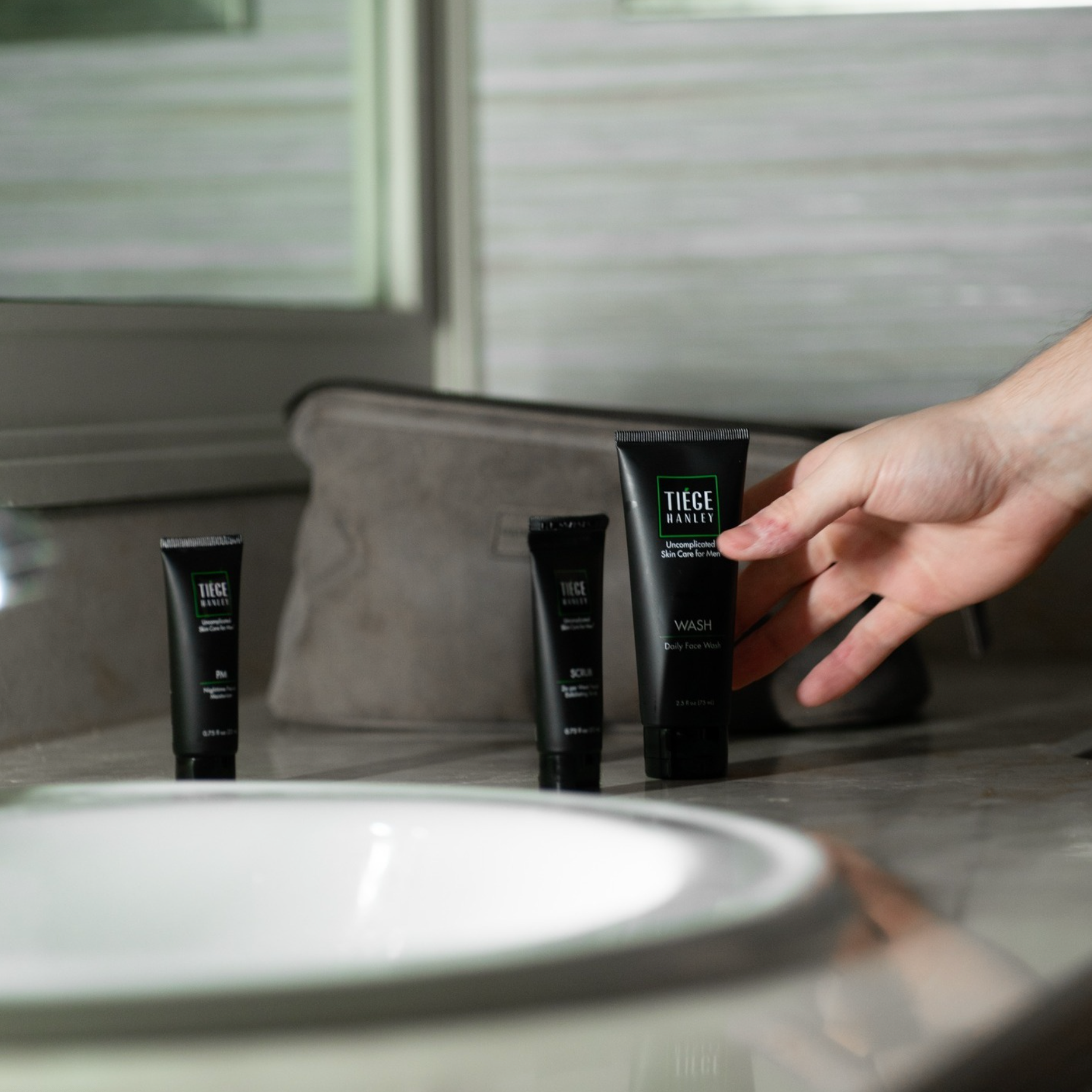 Someone reaching for tiege hanley face wash